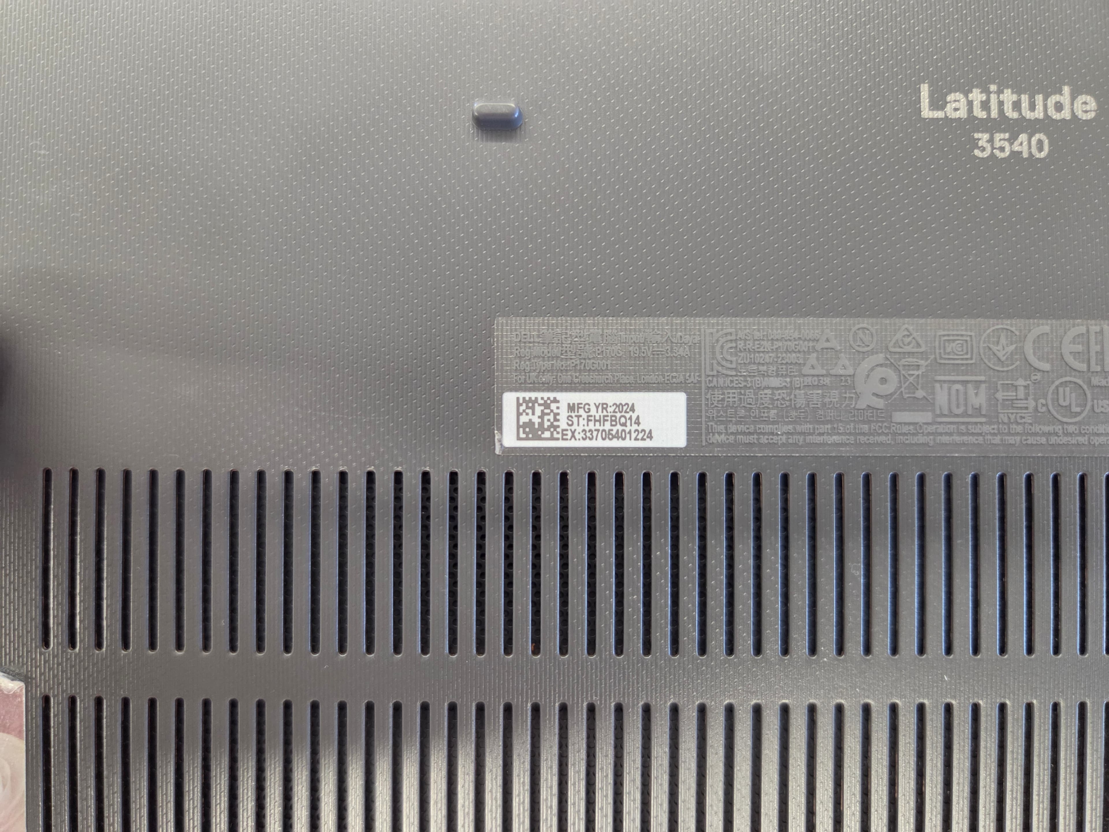 Dell service tag label printed on the underside of a laptop