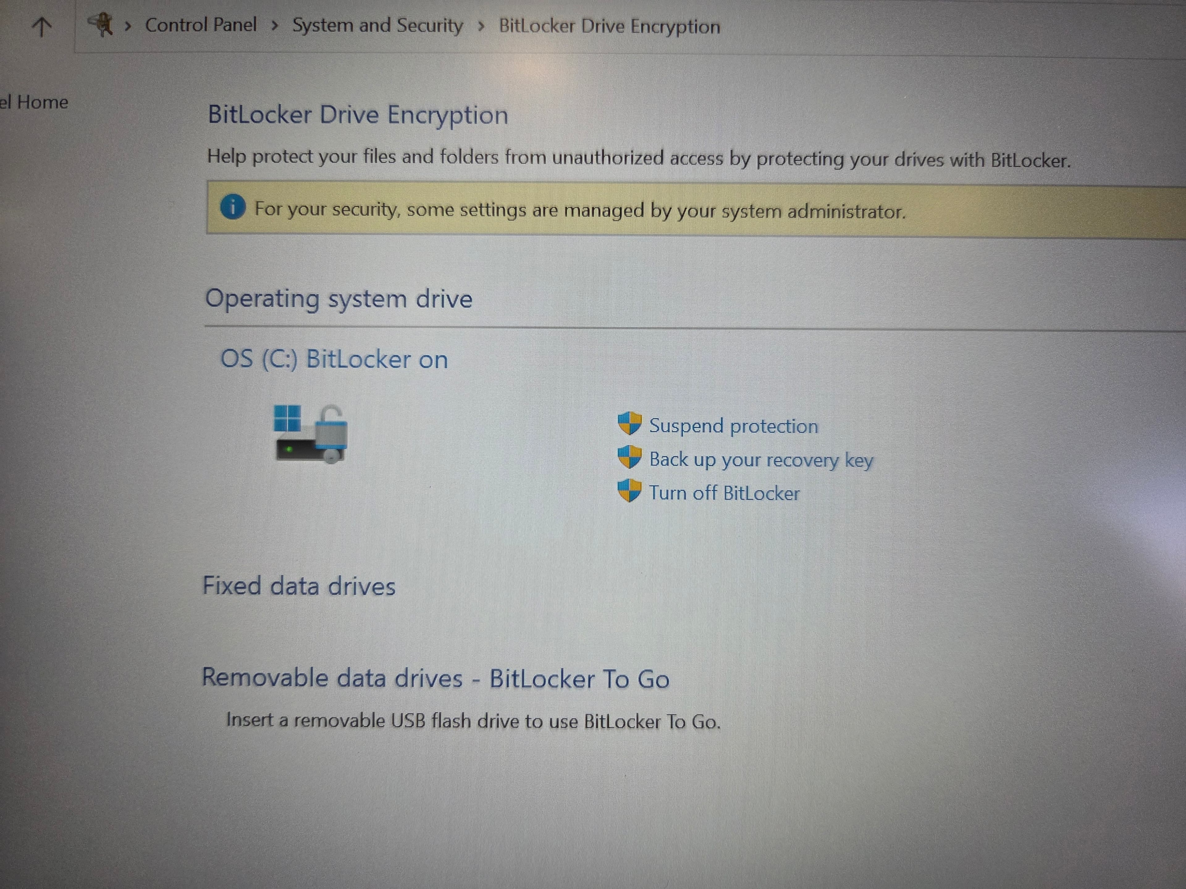 Manage BitLocker window showing the Suspend protection link beside the C: drive